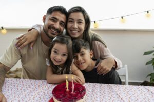 hispanic family portrait with cake celebrating birthday